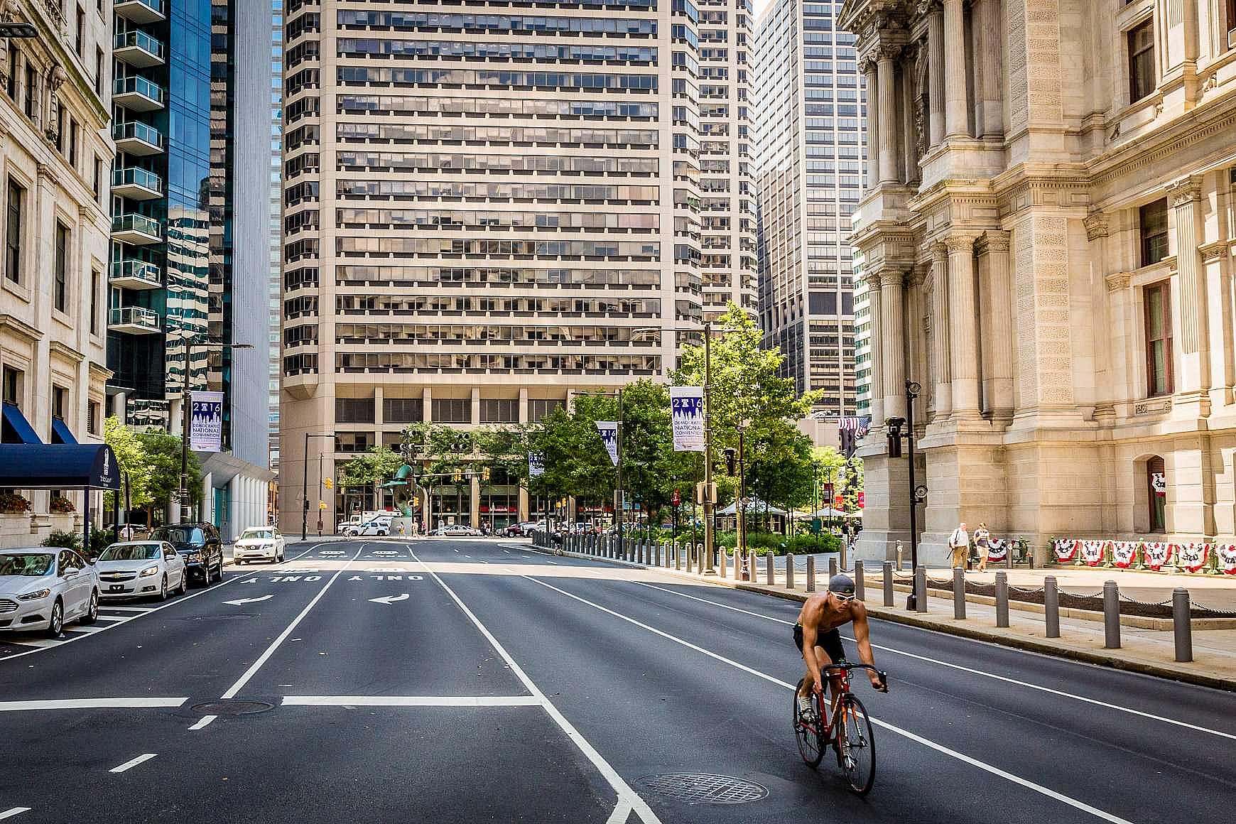 bicycle racer passing in front of City Hall