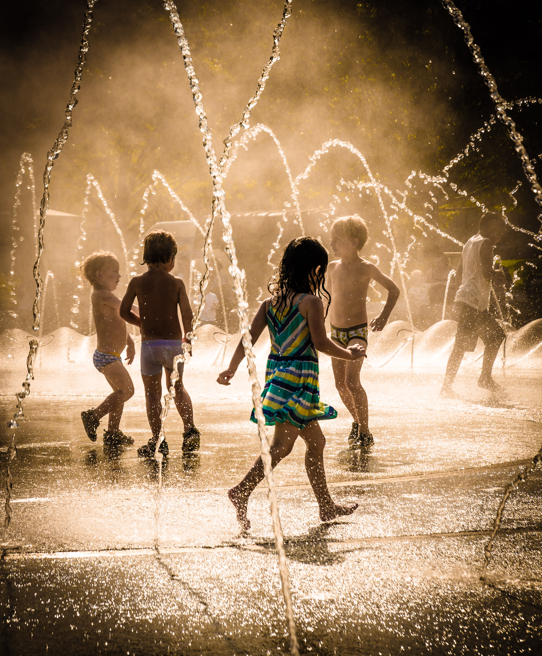 Boys and girls playing in fountain at Polk Bros Park